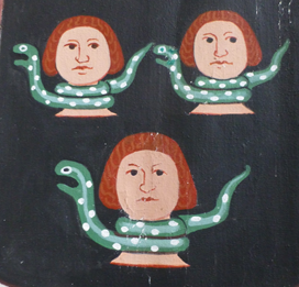 Three boys with spotty green snakes coiled around their necks
