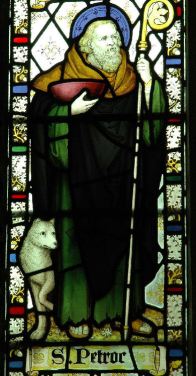 Stained glass window showing Petroc the saint in Bodmin Church. Image in public domain.